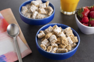 a bowl of cereal with milk and a spoon
