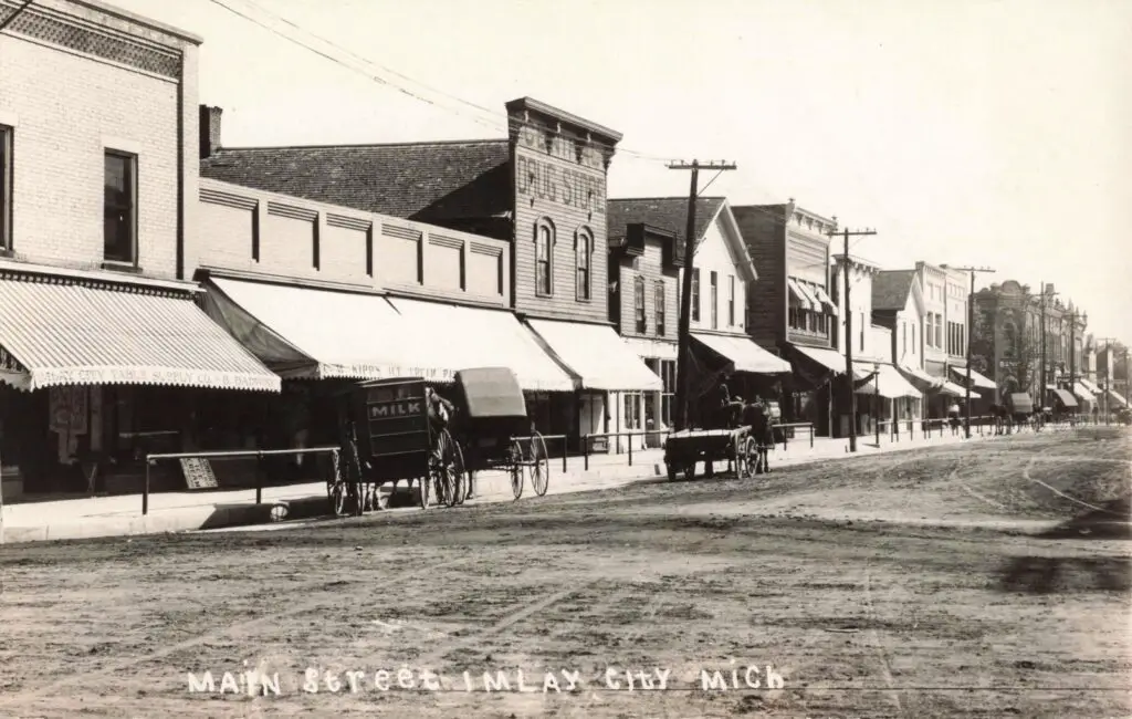 a street with buildings and a horse drawn carriage