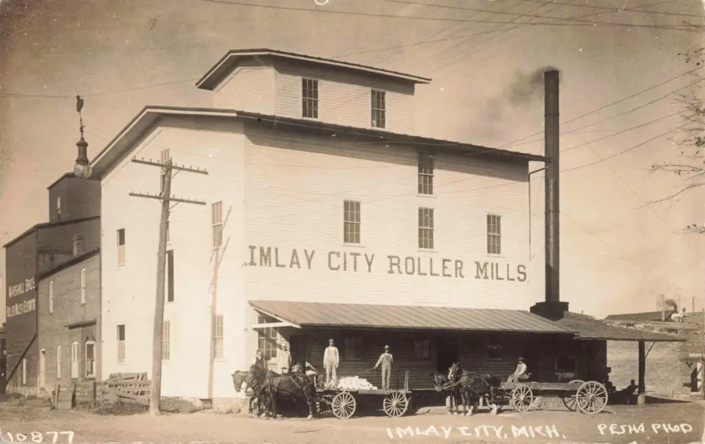 a horse drawn carriage with people in front of a building