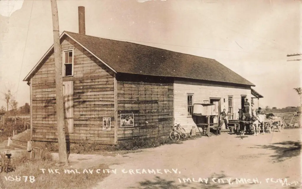 a wooden building with a couple of people outside