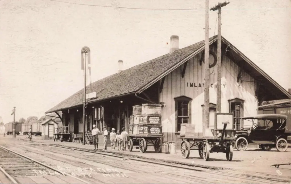 a train station with people walking on the tracks