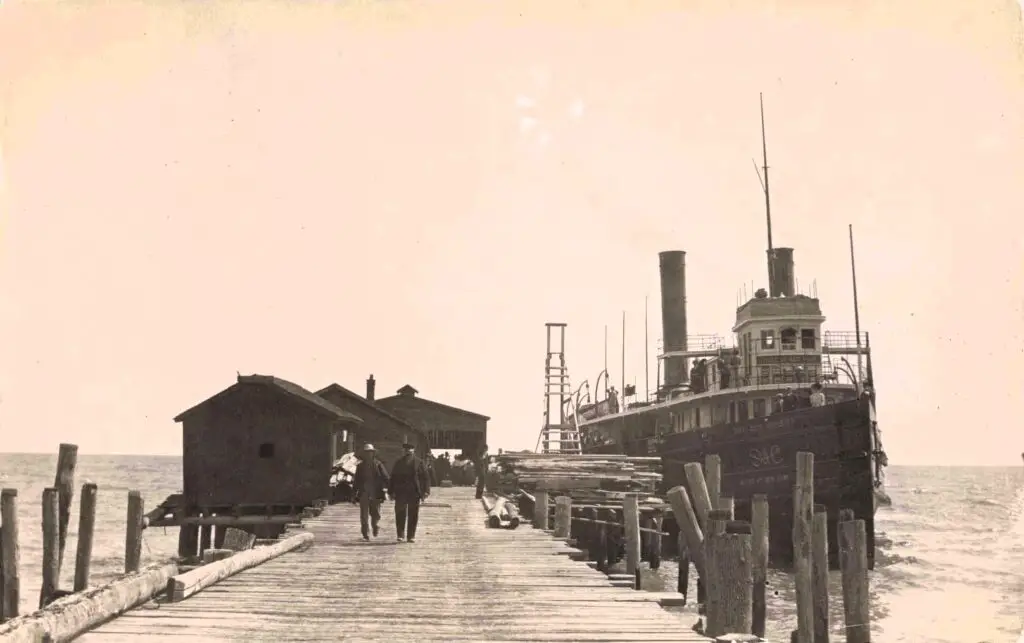 a group of people walking on a dock