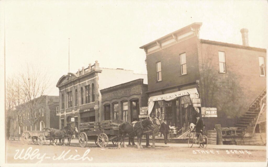 Historic street with horse-drawn wagons.