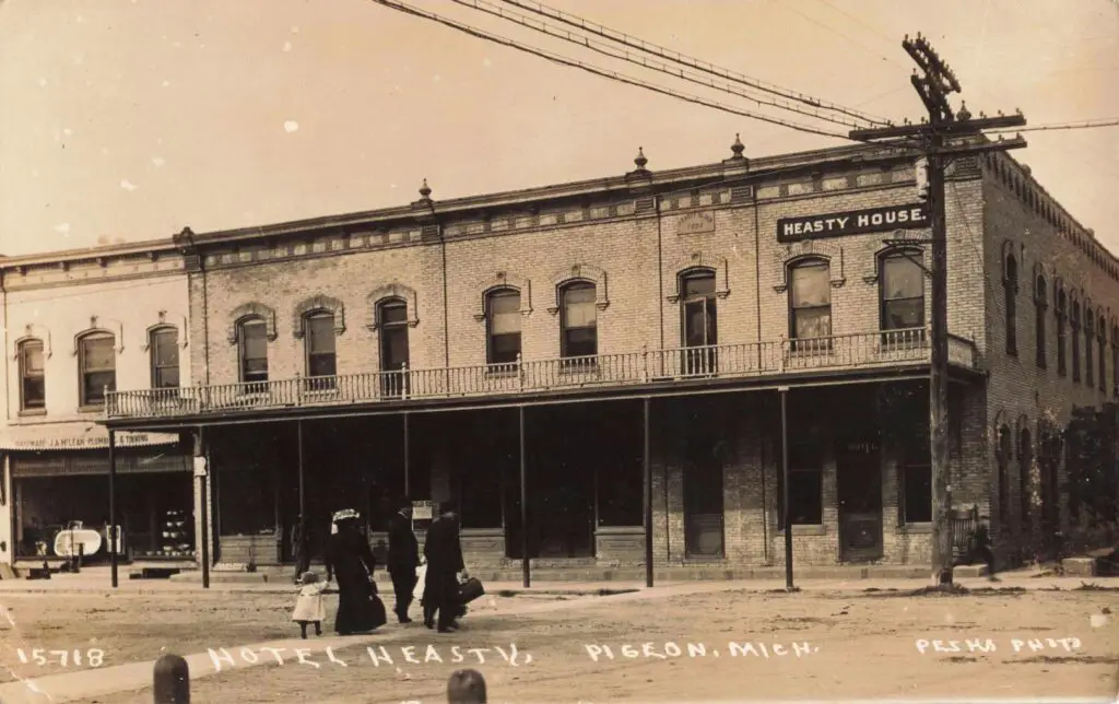 a group of people walking in front of a hotel