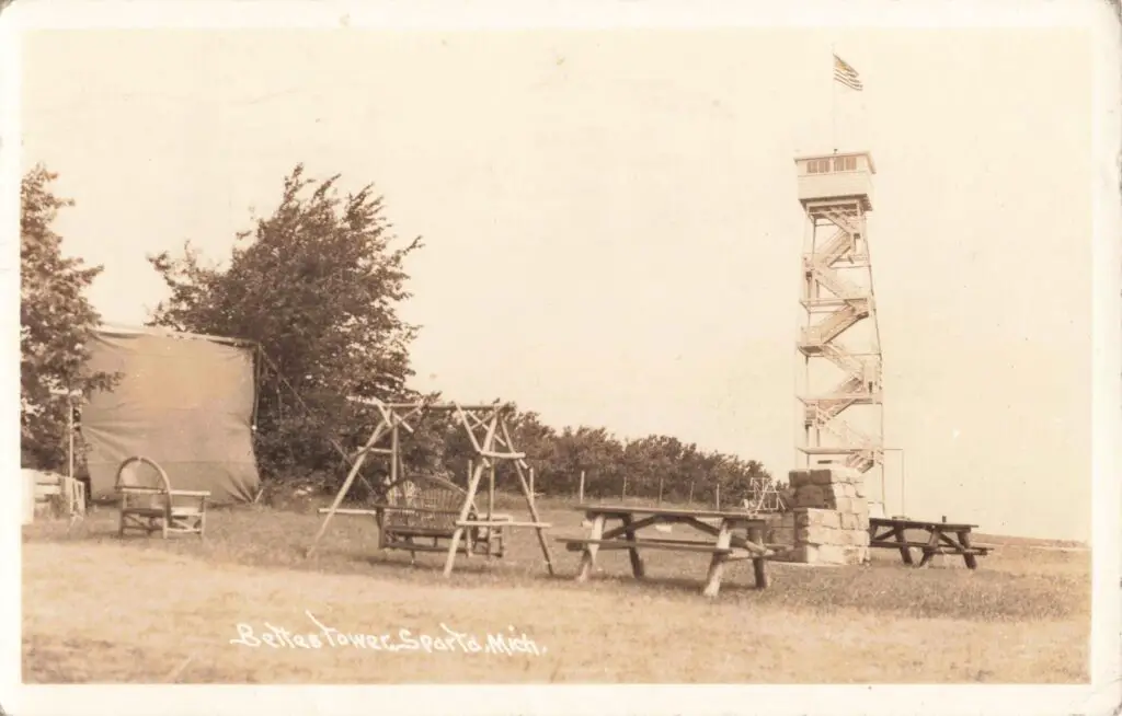 a tower with a flag in the background