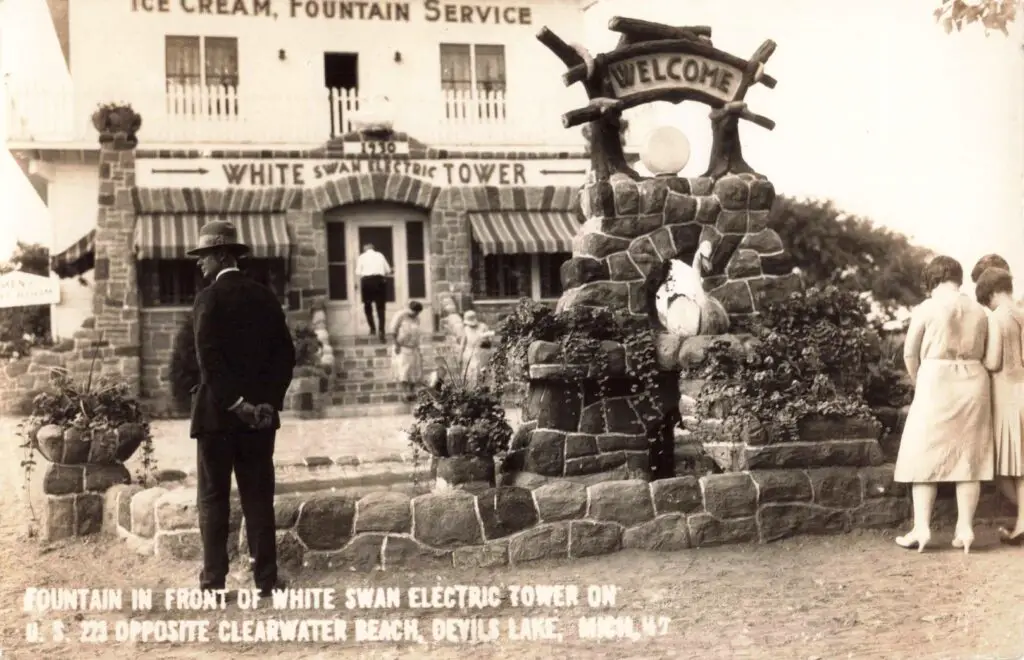 a man standing in front of a stone building