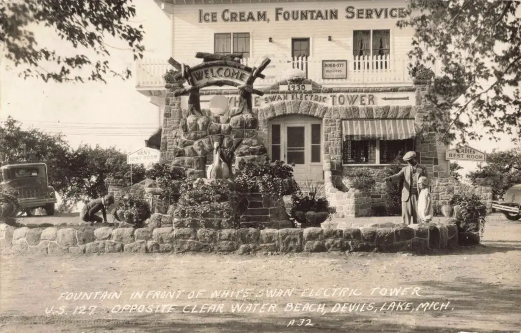 a black and white photo of a building with a sign