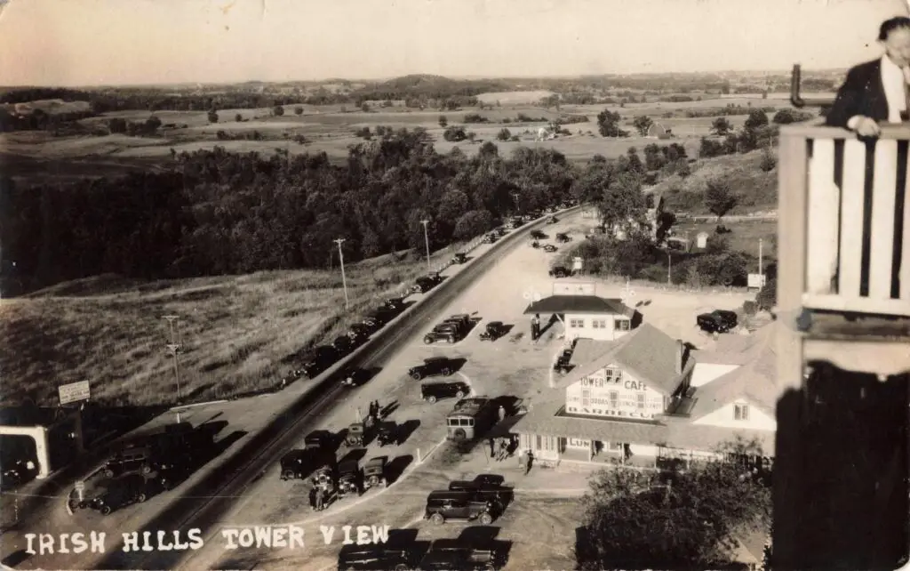 a building with cars parked in front of a road
