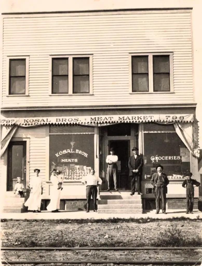 Historic meat market with people outside.