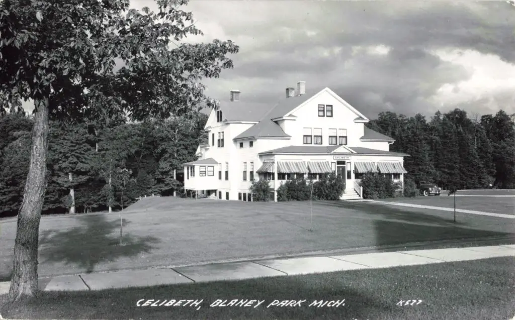 Historic white house in park setting.