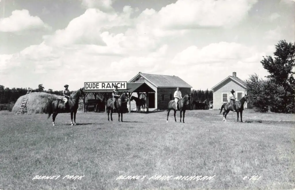 Cowboys on horseback at dude ranch.