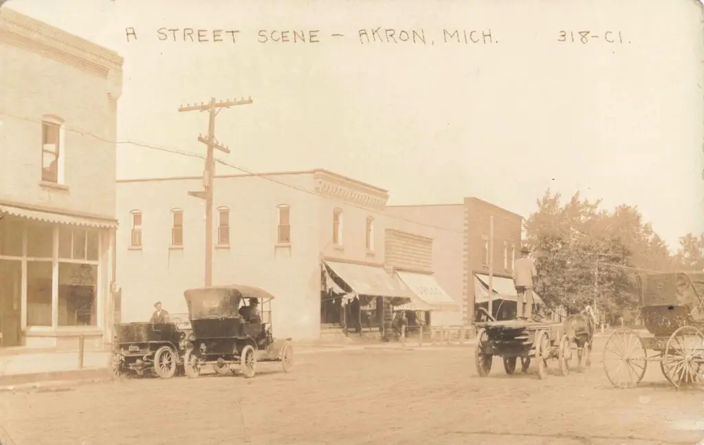 Historic street scene with vintage vehicles.