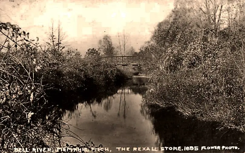 Serene river scene with bridge.