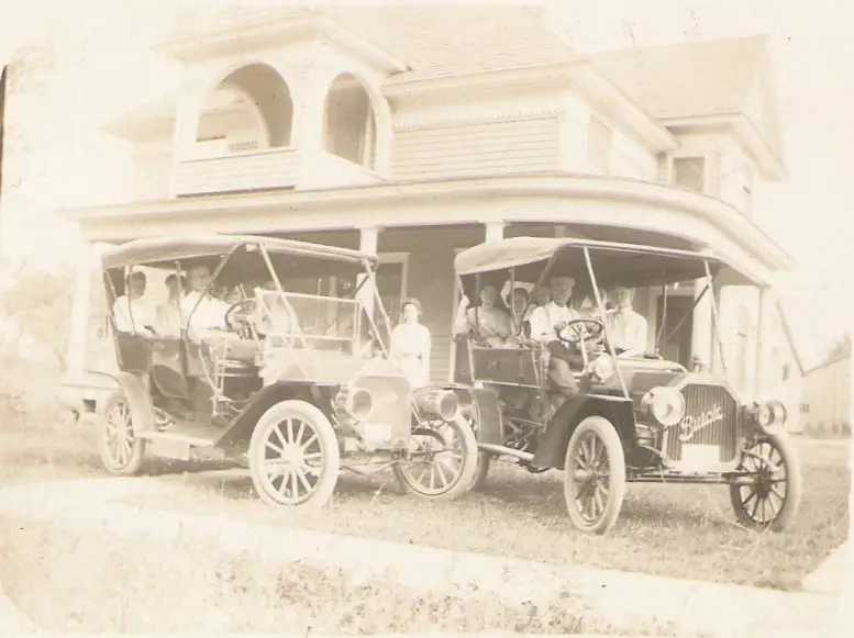 Vintage cars in front of house - History of Memphis Michigan