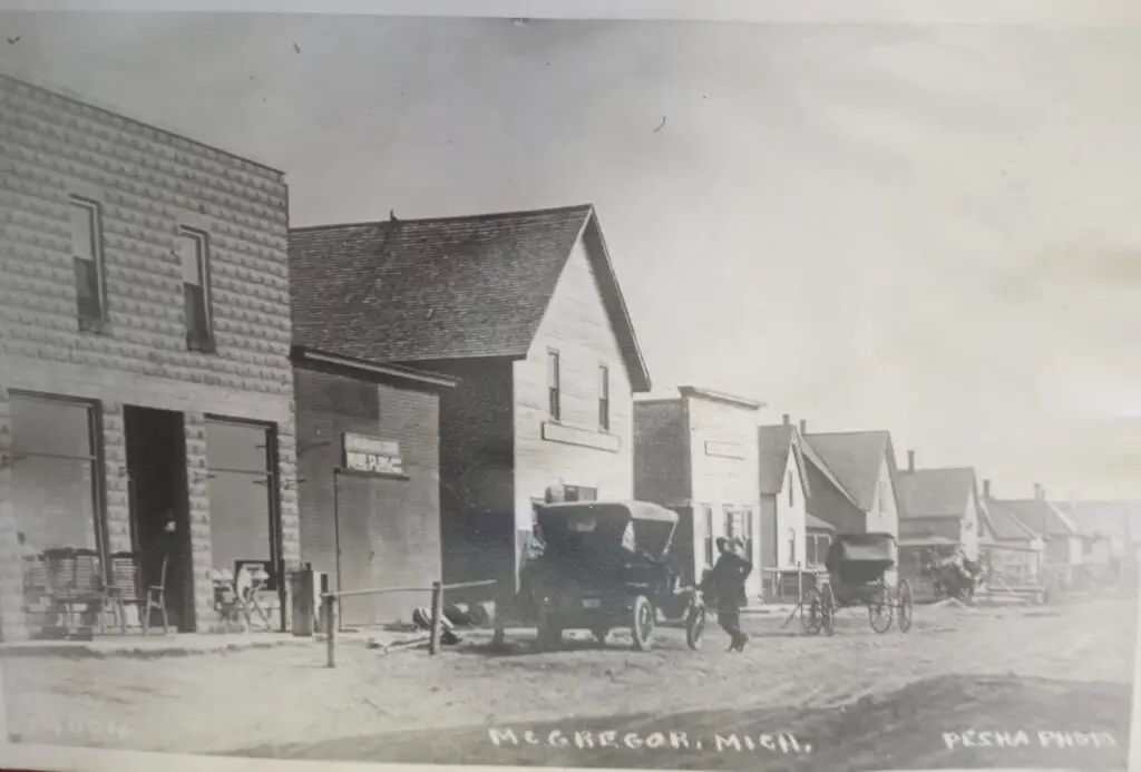 Historic street scene with horse-drawn carriages.
