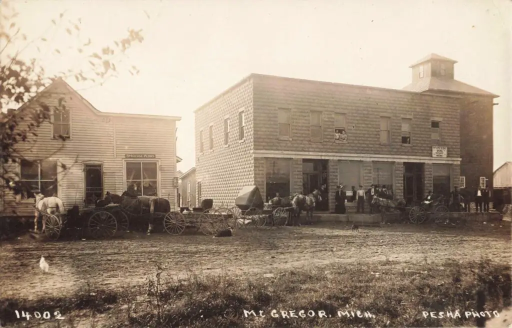 Historic storefront with horse-drawn carriages.