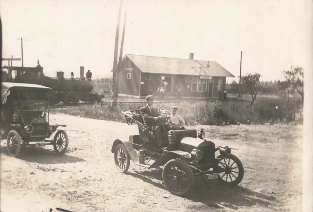 Vintage cars near a train station