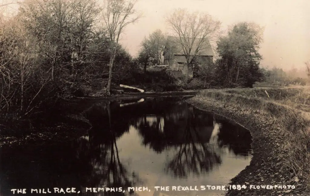 Serene river reflecting trees and Memphis Mill