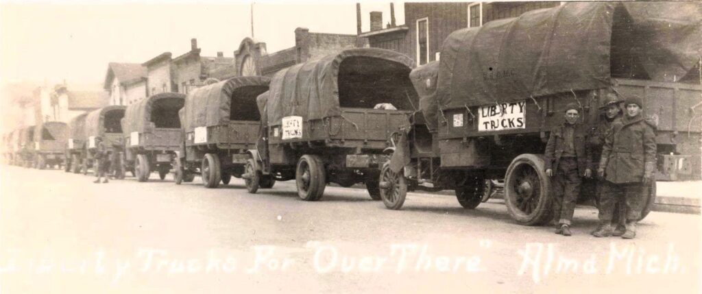 Line of vintage trucks with soldiers.