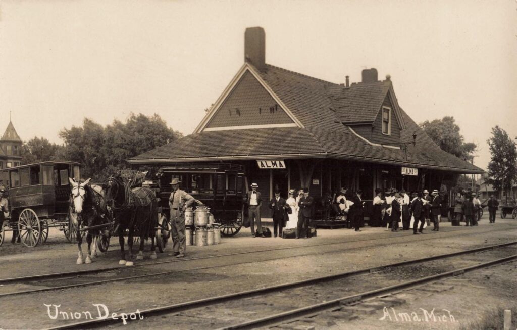 Historic train station with horse-drawn carriages