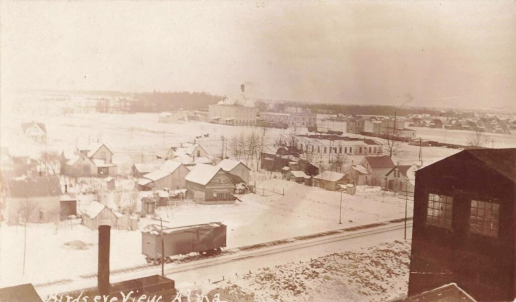 Snow-covered town with wooden buildings.