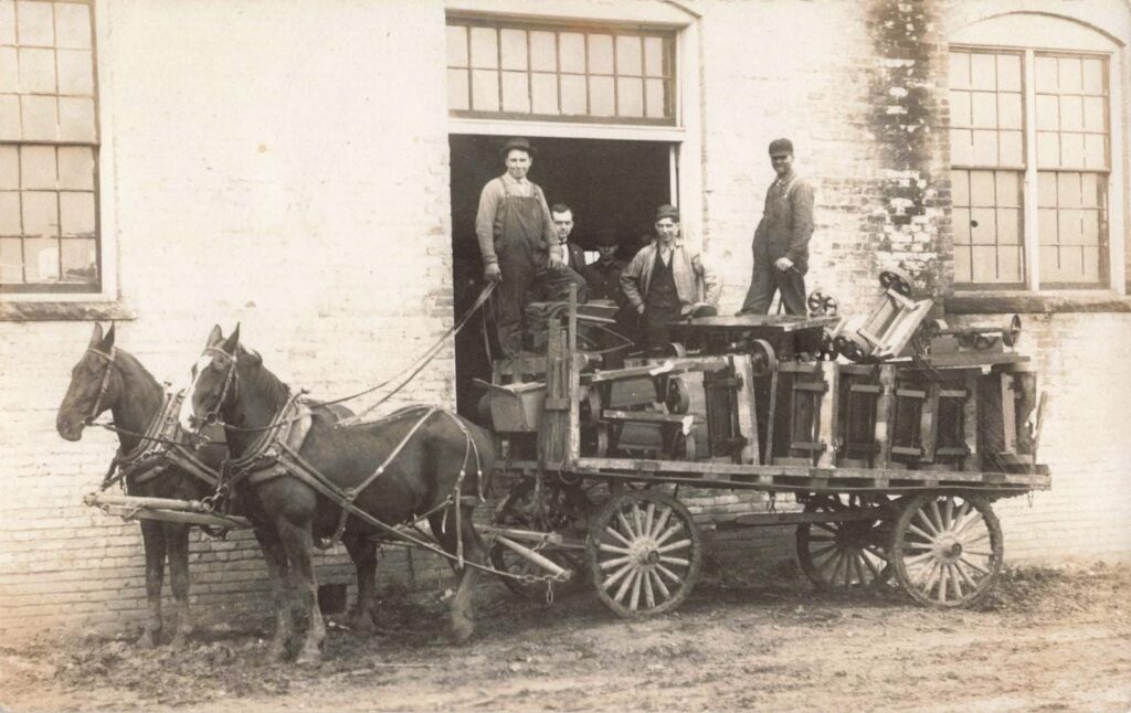 Horse-drawn wagon with people loading.