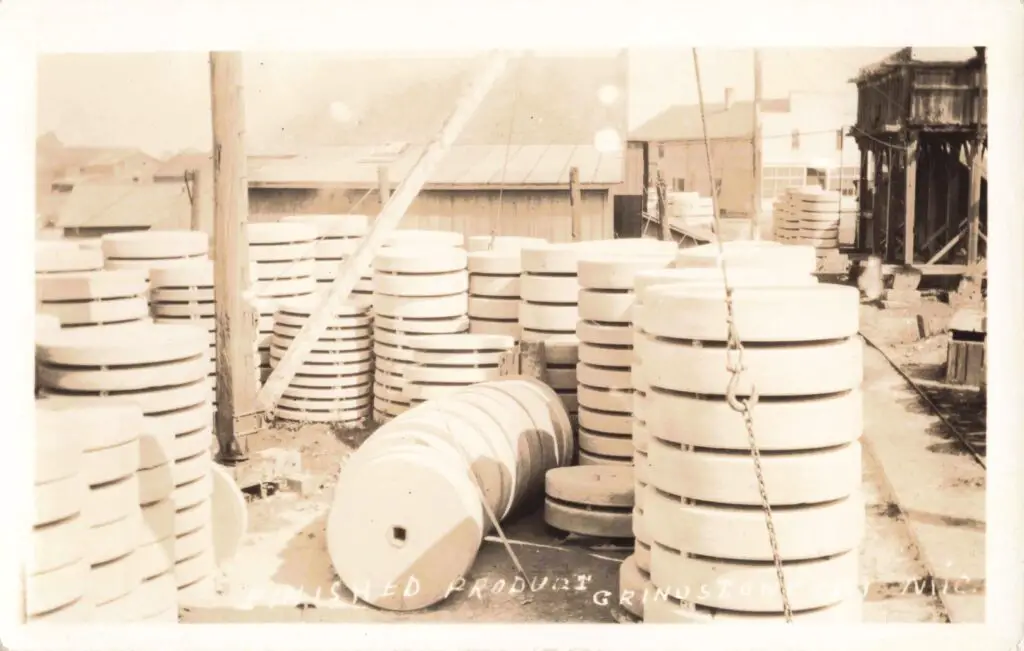 Stacked industrial grinding wheels outdoors.