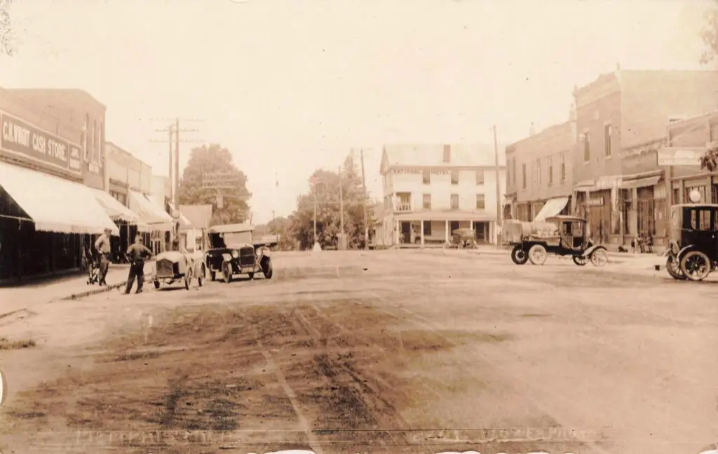 Historic empty street with vintage cars.