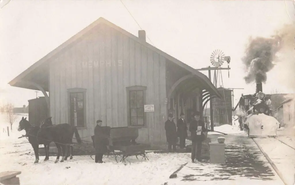Historic train station in snowy landscape.