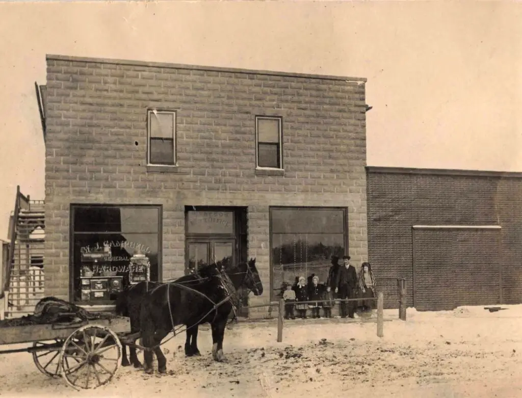 Historic Mcgregor post office and storefront with horse-drawn wagon.