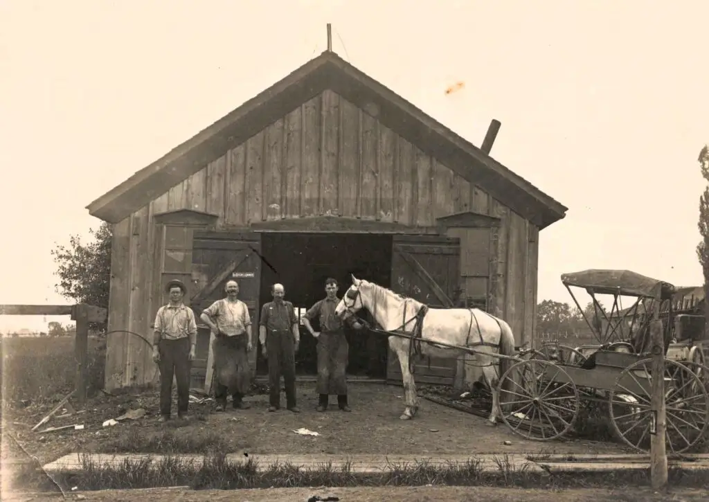 Four men with horse and carriage.