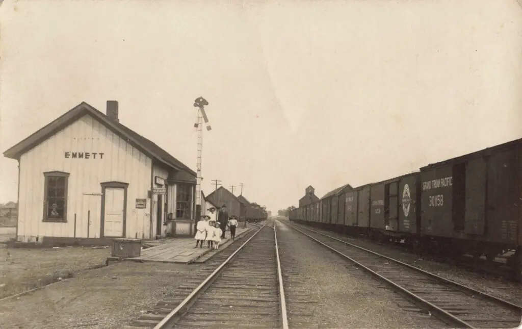 Old train station with people waiting.