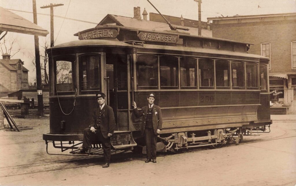 Historic streetcar with two conductors.