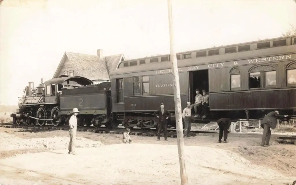 Historic train with people and buildings