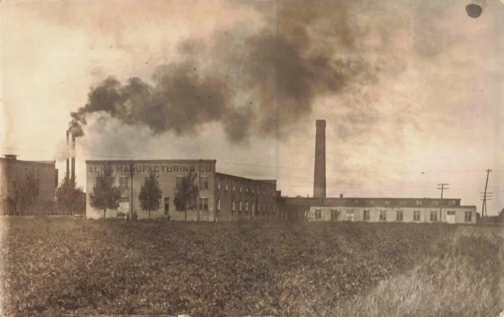 Old factory with smoke and fields