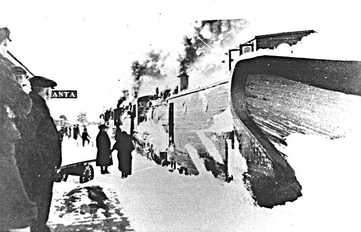 Snow-covered train clearing tracks