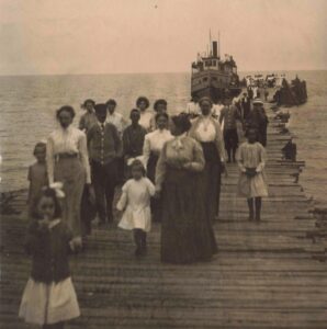 Point Au Gres dock (1909). Vacationers disembark a small steamboat at Pointe Lookout. Lake Huron vistas and fresh air drew summer visitors.