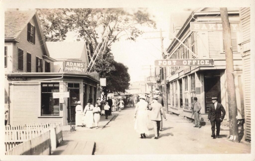 History of Saugatuck Michigan street with shops and pedestrians.