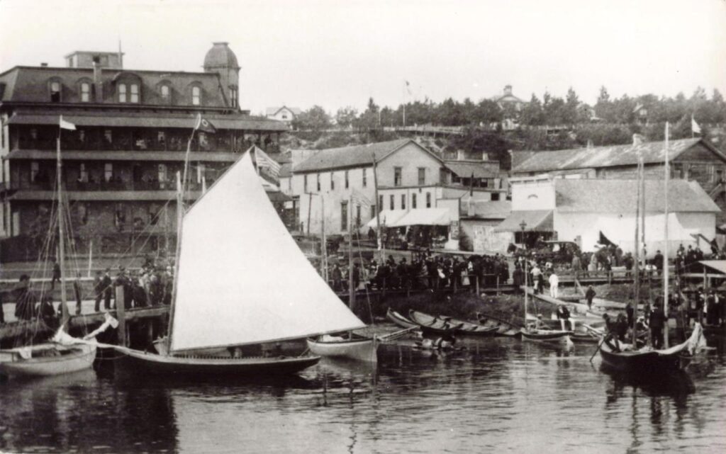 Historic waterfront with boats and buildings.