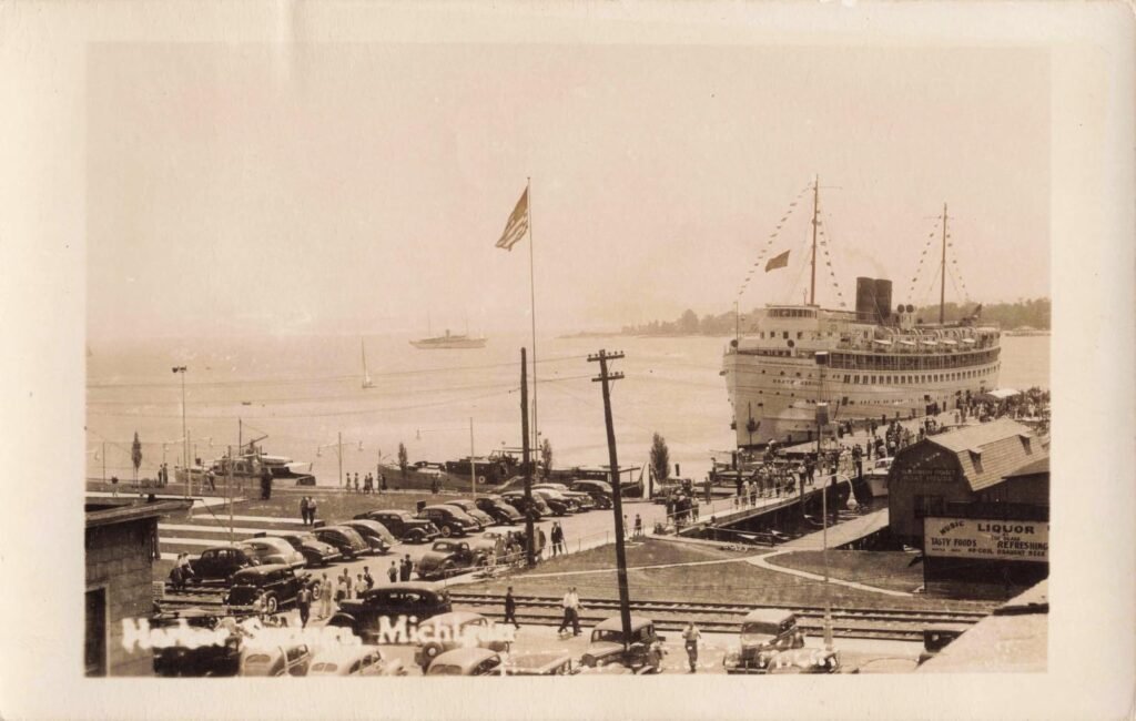 Historic waterfront with vintage cars.