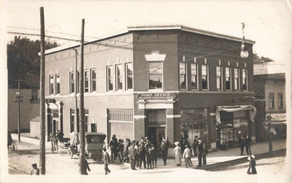 Historic post office building with people