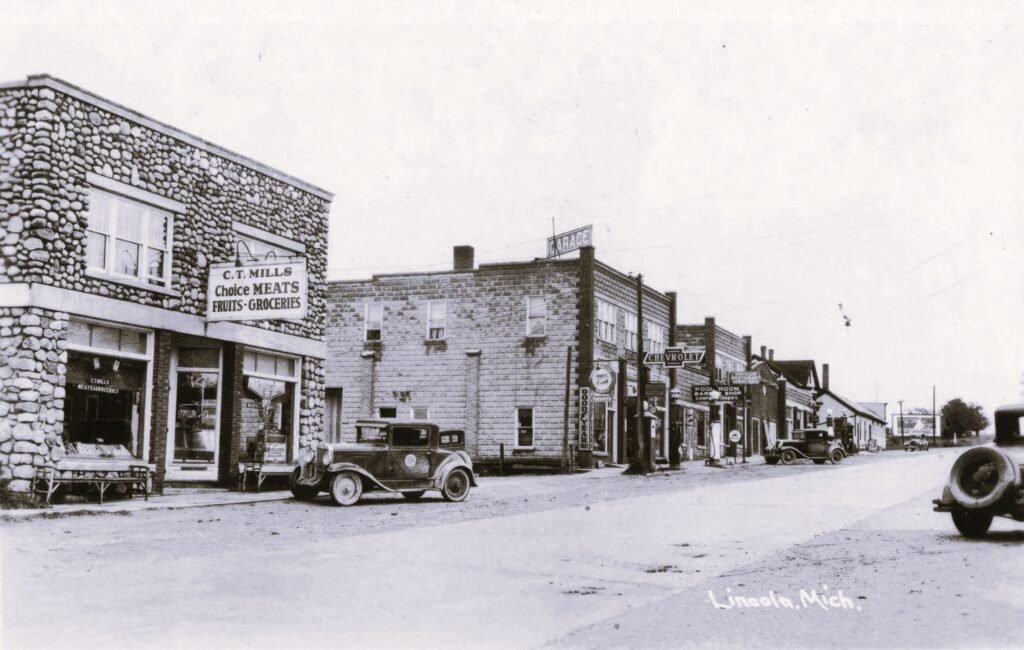 Historic street scene with vintage cars.