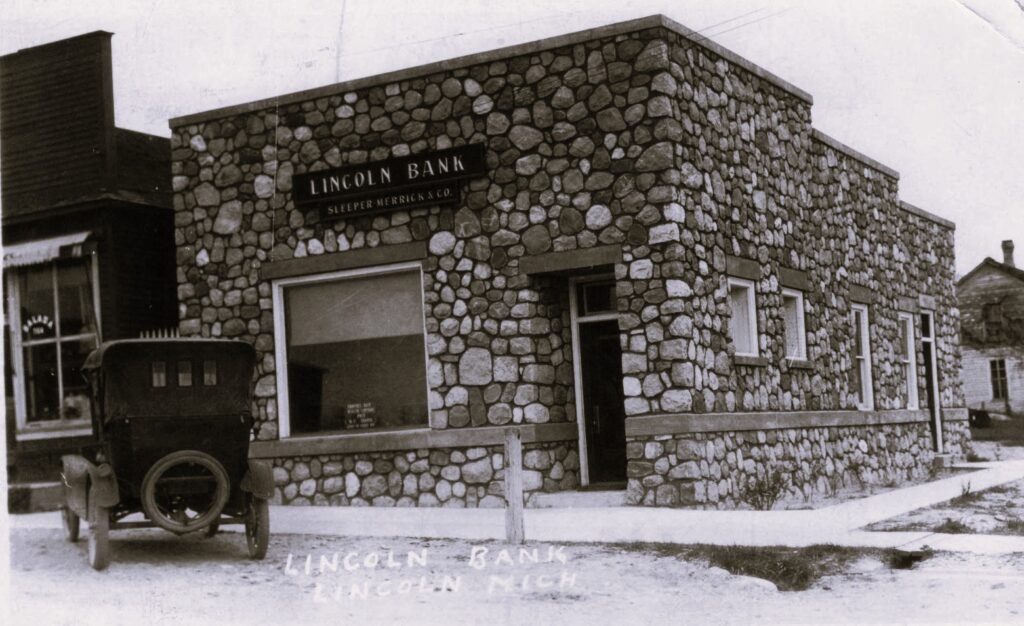 Historic stone building with vintage car