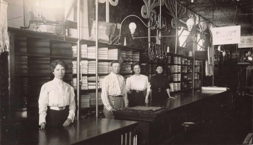 Vintage store with four individuals standing.