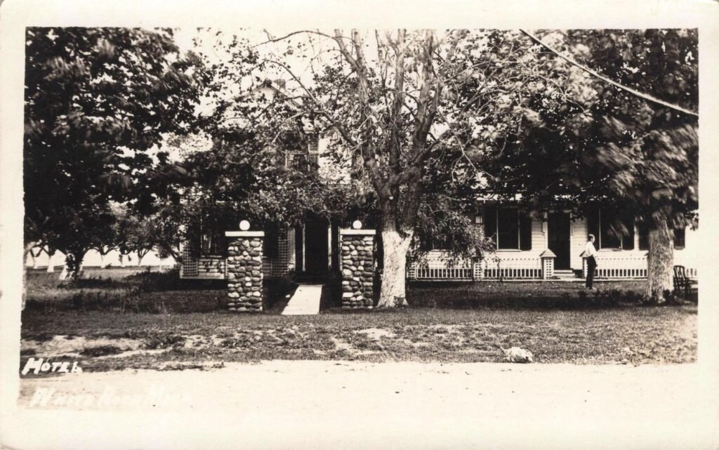 Historic hotel surrounded by trees.