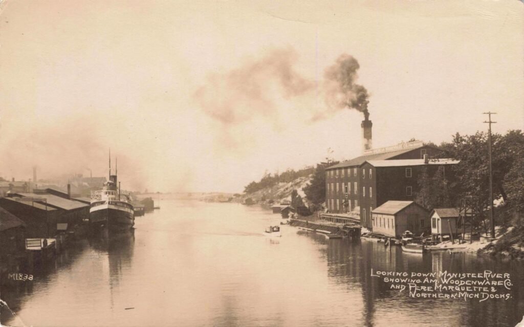 Historic river scene with smokestacks.