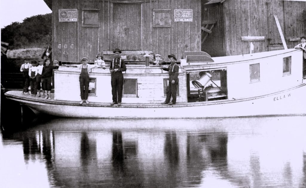 Historic boat with people on board.