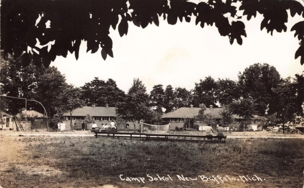 Historic camp scene with buildings.