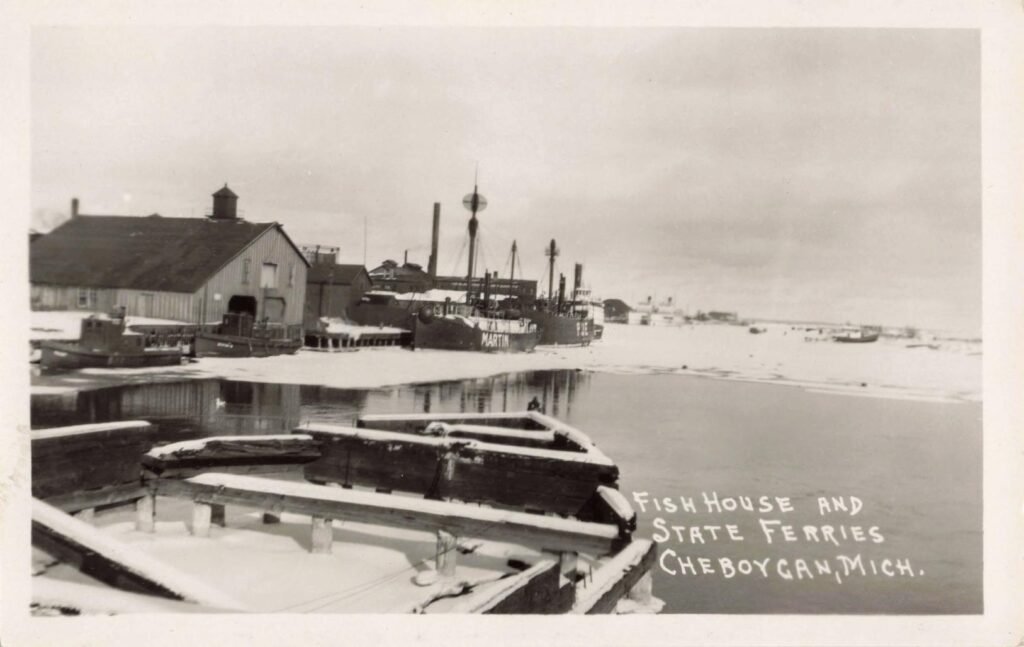 Historic boats at frozen Cheboygan harbor.