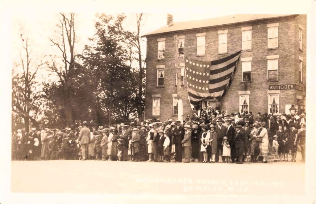 Brick Walker Tavern exterior, three stories, later used for antiques and events.